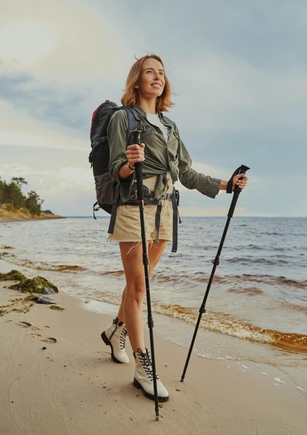optimistic-traveller-using-walking-poles-during-beach-stroll-1-q0vp3niy63g0y3kkybh9jeuwlqg6h3dkoqqyzlxx6c